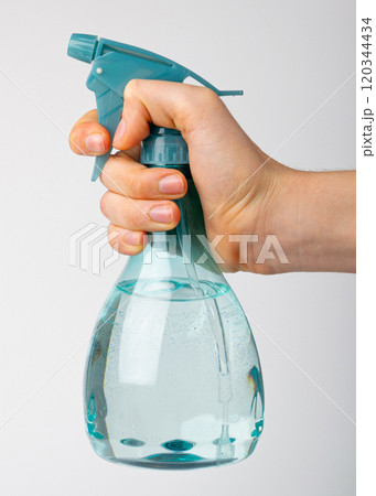 Spray Bottle in Hand Isolated, Blue Sprayer with Water, Mini Flower Spray Gun, Plastic Pulverizer on White Spray Bottle in Hand Isolated, Blue Sprayer with Water, Mini Flower Spray Gun, Plastic Pulverizer on White 120344434