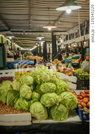 Fresh organic vegetables with cabbage in foreground sold at a stall of farmers market Fresh organic vegetables with cabbage in foreground sold at a stall of farmers market 120345220