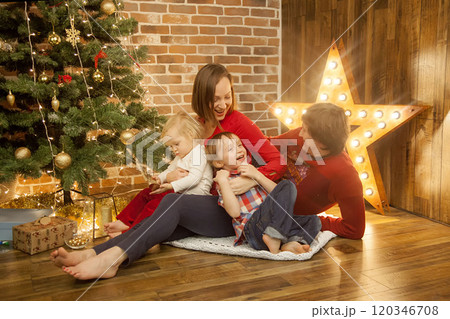 Heartwarming scene of a family celebrating Christmas Heartwarming scene of a family celebrating Christmas 120346708