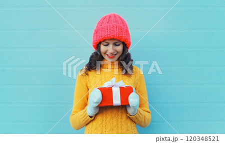 Christmas portrait of happy young woman smiling holding holiday gift box, cheerful girl celebration Christmas portrait of happy young woman smiling holding holiday gift box, cheerful girl celebration 120348521