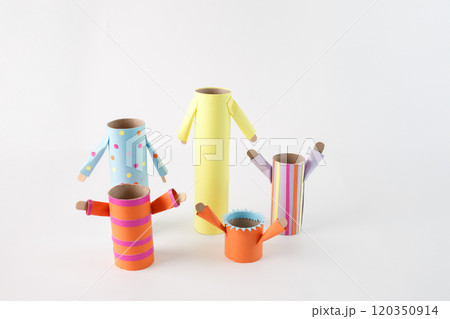 step in creative DIY project, empty cardboard rolls and tubes transformed into The bodies, are wrapped in different colored and patterned paper, and the arms are made from paper as well 120350914
