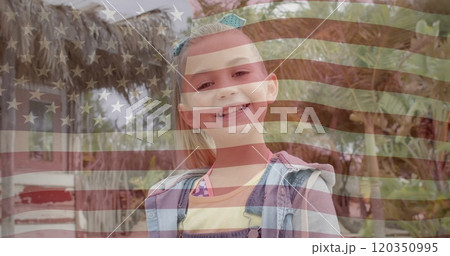 Image of american flag over porttrait of smiling caucasian girl in sunny garden Image of american flag over porttrait of smiling caucasian girl in sunny garden 120350995