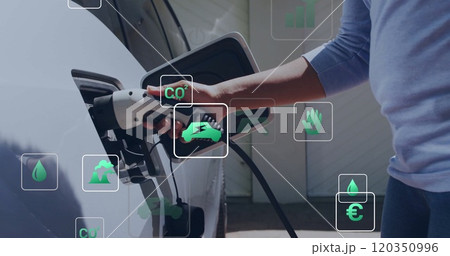 Image of eco icons and data processing over caucasian man charging electric car 120350996