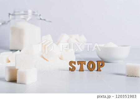 Concept of limited sugar consumption, text and sugar on the table 120351983