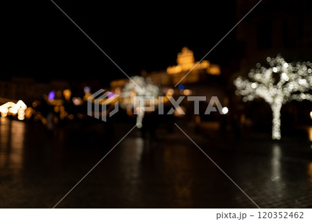 Abstract Christmas street background of garland lights in the dark. Christmas lights defocused. 120352462