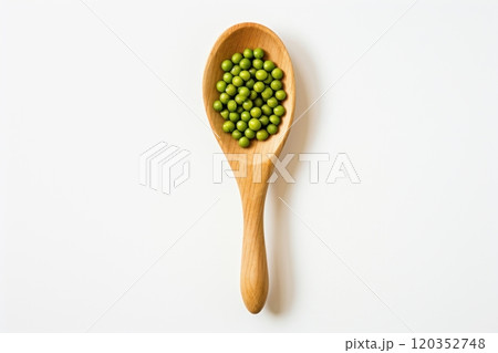 Top view of wooden spoon with green peas on a white background. Healthy vegetarian food, rich in protein and vitamins. Perfect for cooking, recipe or food related content 120352748