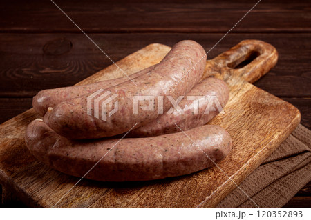 raw sausages in English with bacon, for grilling, on a cutting board, top view, no people, 120352893