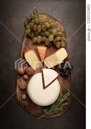 Georgian cheese, Imeretian and smoked suluguni, grapes, nuts, on a cutting board, Georgian cuisine, no people, Georgian cheese, Imeretian and smoked suluguni, grapes, nuts, on a cutting board, Georgian cuisine, no people, 120352903