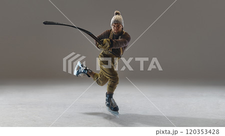 Man wearing pants with suspenders, knitted warm sweater and hat, in motion with stick, hitting puck. Winter sports and activity Man wearing pants with suspenders, knitted warm sweater and hat, in motion with stick, hitting puck. Winter sports and activity 120353428