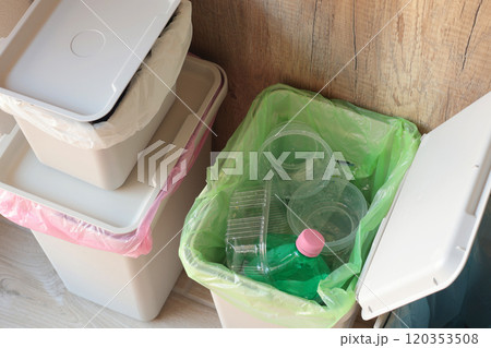 Separate sorting of garbage at home. Colorful bags and containers. Ecology and safe waste.  120353508