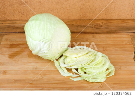 Sliced white cabbage on wooden background. Sliced white cabbage on wooden background. 120354562