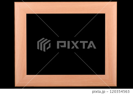 Wooden photo frame with thick cardboard backing on a black background. Wooden photo frame with thick cardboard backing on a black background. 120354563