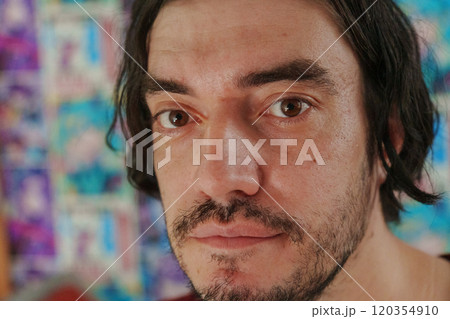 Man with tousled hair gazes thoughtfully into the distance amidst a lively atmosphere Man with tousled hair gazes thoughtfully into the distance amidst a lively atmosphere 120354910