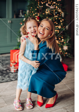Little girl and her mom on Christmas morning at Little girl and her mom on Christmas morning at 120356271