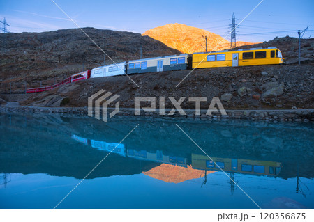 Bernina express train and alpine lake with colorful reflections Bernina express train and alpine lake with colorful reflections 120356875