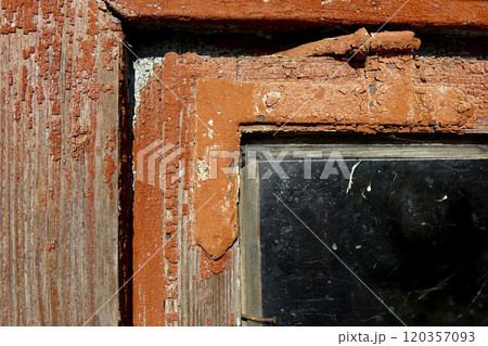 Close-up of Old Painted Wooden Window Revealing Weathered Textures and Glass Details in Rustic Home 120357093