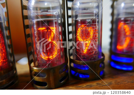 Retro Nixie lamp indicator clock on dark background. The Nixie tube indicator of the numbers of retro style. Retro Nixie lamp indicator clock on dark background. The Nixie tube indicator of the numbers of retro style. 120358640