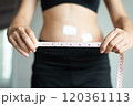 Patient woman hands holding measuring tape for measure size wound after surgery on white background 120361113