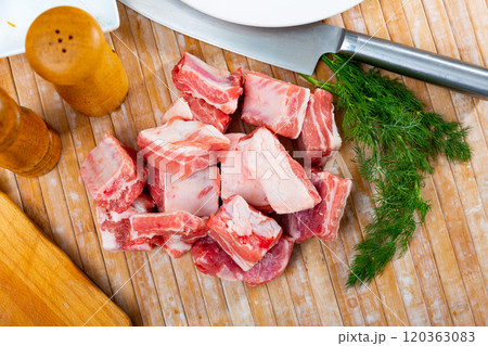 Chopped raw pork ribs on top of table 120363083