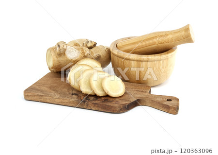 Fresh ginger root and slices with mortar and pestle 120363096