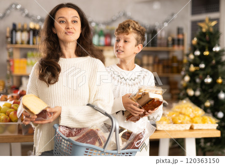 Adult woman with son choosing products in grocery store Adult woman with son choosing products in grocery store 120363150