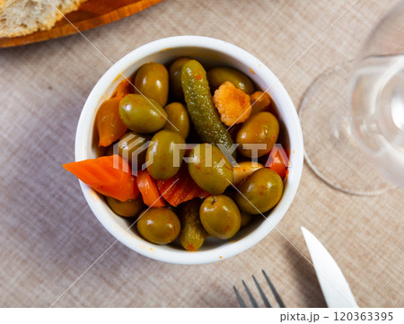 Light snack - oval bowl with pickled vegetables, gherkin and green olives Light snack - oval bowl with pickled vegetables, gherkin and green olives 120363395