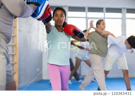 Coach and girl training boxing technique 120363431