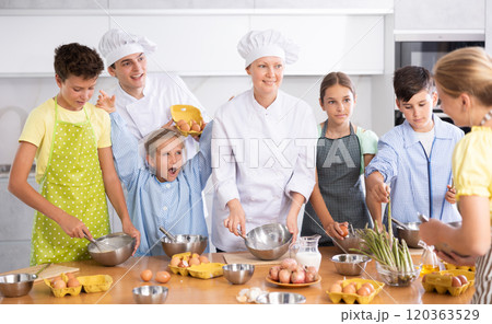 During childrens cooking class, little girl screams enthusiastically and raised two hands up. During childrens cooking class, little girl screams enthusiastically and raised two hands up. 120363529