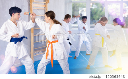 Boy and girl training karate techniques in studio 120363648