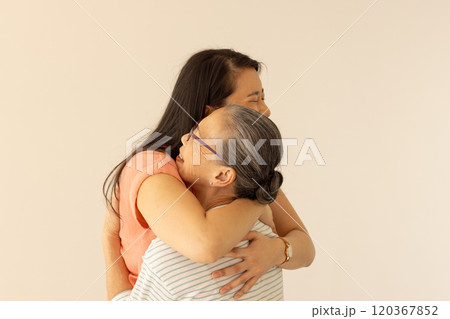 Hugging each other, asian grandmother and granddaughter sharing warm embrace 120367852