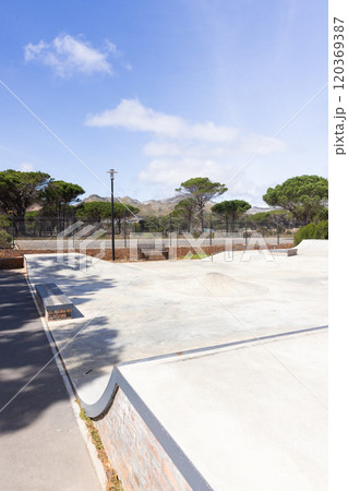 Outdoors, Empty skate park with benches and trees, ready for students to hang out Outdoors, Empty skate park with benches and trees, ready for students to hang out 120369387