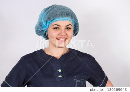 Portrait of a young smiling nurse with a medical cap on her hair. Healthcare concept 120369648