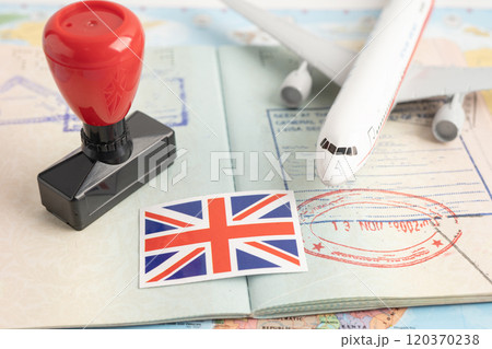Approved Stamp passport with United Kingdom flag document to immigration at airport in country. Approved Stamp passport with United Kingdom flag document to immigration at airport in country. 120370238