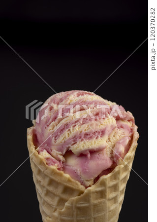 waffle cone with ice cream and pieces of melon and watermelon 120370282