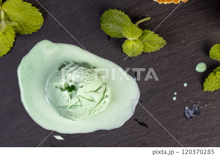 green ice cream with mint flavor on a black slate surface 120370285