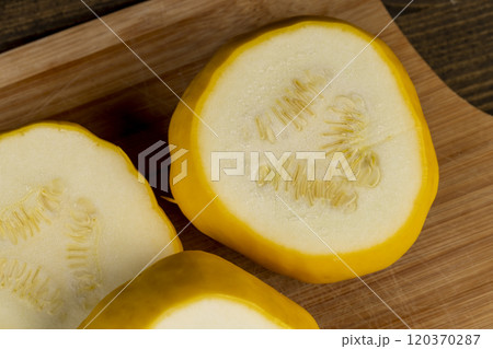 cut yellow ripe pumpkins on the table in close-up 120370287