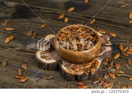 , overcooked or burnt pumpkin seeds on the table 120370303