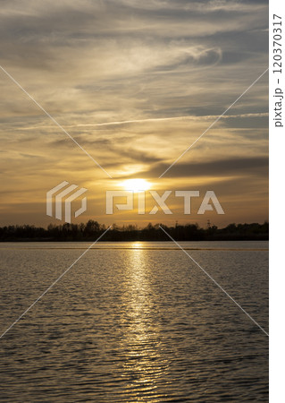 orange sunset is reflected in the water of the lake orange sunset is reflected in the water of the lake 120370317