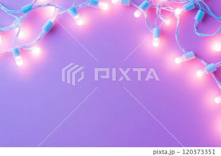 Glowing string lights scattered across a pastel pink background 120373351