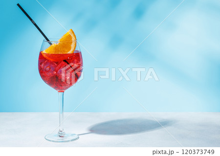 A cocktail arranged on a table against a light blue background A cocktail arranged on a table against a light blue background 120373749