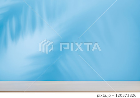 Template with empty table and wall with natural plant shadow and sunny glare 120373826