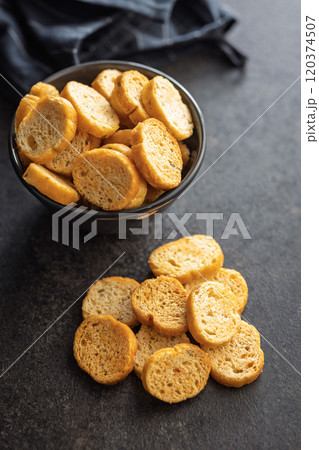 Sliced roasted bruschetta bread on black table. Sliced roasted bruschetta bread on black table. 120374507