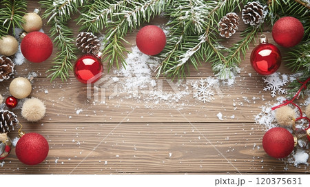 Beautifully Arranged Christmas Decorations With Red Ornaments and Pinecones on a Wooden Surface 120375631