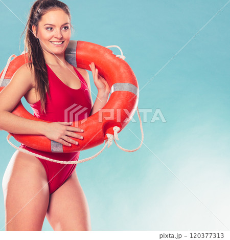 Lifeguard woman on duty with ring buoy lifebuoy. 120377313