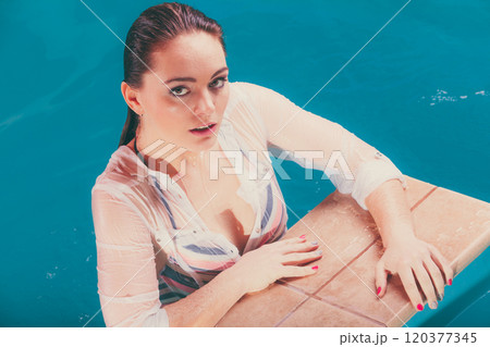 Portrait of sexy seductive woman at poolside water Portrait of sexy seductive woman at poolside water 120377345