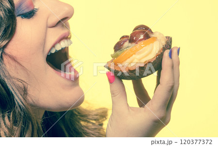 Closeup woman eating fruit cake sweet food 120377372