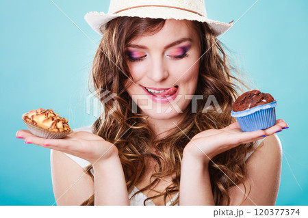 Smiling summer woman holds cakes in hand Smiling summer woman holds cakes in hand 120377374