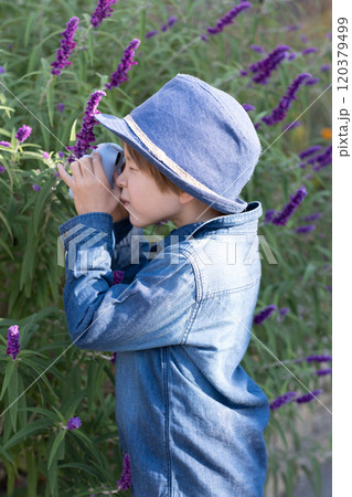 Little boy taking photo in Autumn season. Little boy taking photo in Autumn season. 120379499