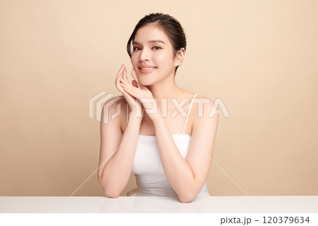 Beautiful young asian woman with clean fresh skin on beige background, Face care, Facial treatment, Cosmetology, beauty and spa, Asian women portrait. 120379634