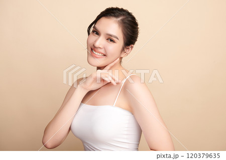 Beautiful young asian woman with clean fresh skin on beige background, Face care, Facial treatment, Cosmetology, beauty and spa, Asian women portrait. 120379635
